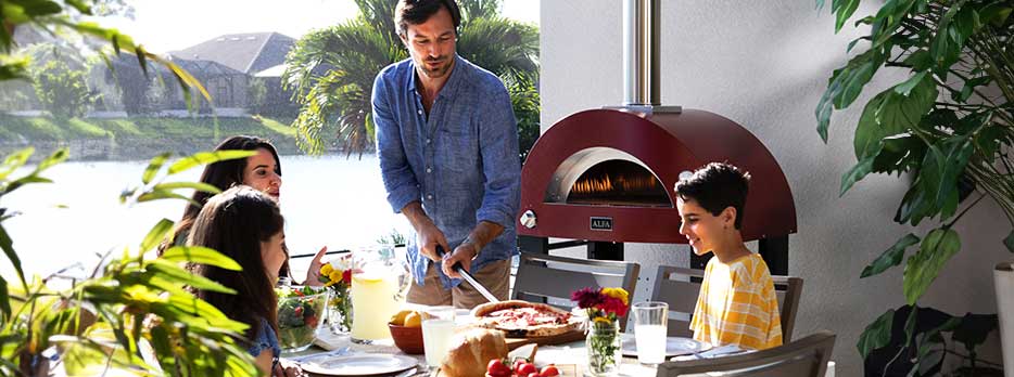 Alfa 2 Pizze Moderno Pizza oven on a patio with a family getting ready to enjoy a cooked pizza