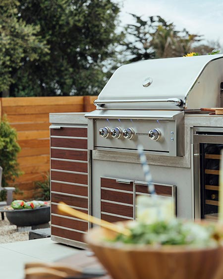 Summerset Alturi grill with custom built outdoor cabinet with wood inlay